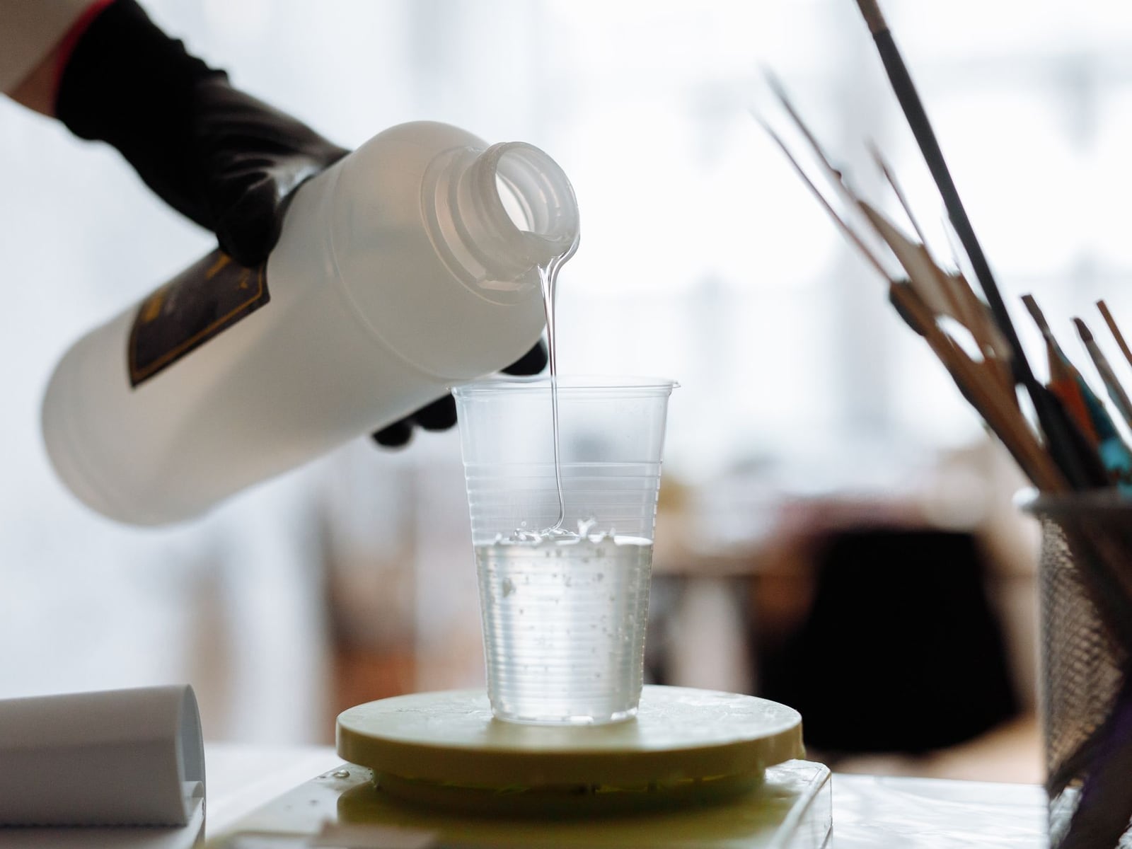 High-precision resin model being lifted from the liquid vat of an SLA printer.